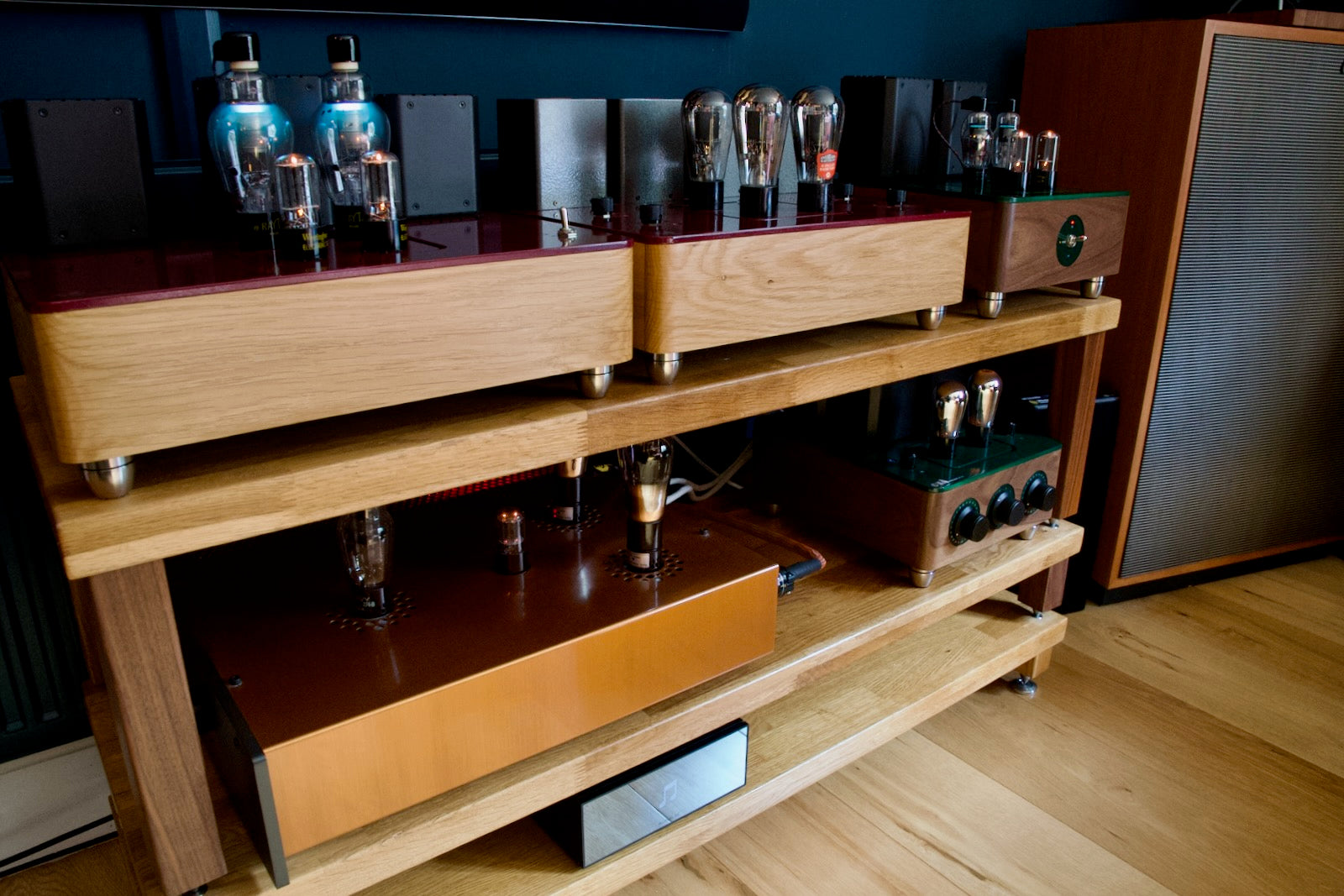 Wooden audio equipment rack with valve 
amplifiers in a home setting